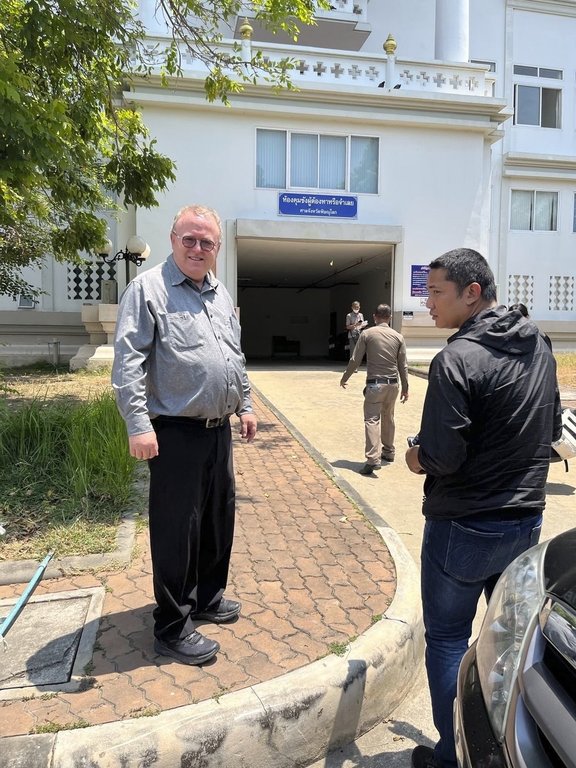 U.S. political science lecturer Paul Chambers,left, of Thailand's Naresuan University, stands outside the police station in Phitsanulok, Thailand, where he was arrested on Tuesday, April 8, 2025, on charges of insulting the monarchy. (AP Photo)