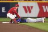 Texas Rangers' Josh Smith steals second base before Cincinnati Reds' Matt McLain can apply the tag in the ninth inning of a baseball game Tuesday, April 1, 2025, in Cincinnati. (AP Photo/Kareem Elgazzar)