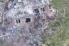 This image taken from video that European military officials say was filmed by a Ukrainian drone in the southern Ukrainian village of Piatykhatky on March 13, 2025, shows a soldier, left, identified as Russian, pointing his gun at a Ukrainian soldier who appears to be surrendering after emerging from the ruins of a house to join other Ukrainian prisoners on the ground. (Ukraine Military/European Defense Officials via AP)