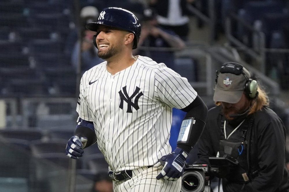 New York Yankees' J.C. Escarra, left, reacts after hitting a home run during the eighth inning of the second baseball game of a doubleheader against the Toronto Blue Jays, Sunday, April 27, 2025, in New York. (AP Photo/Pamela Smith)