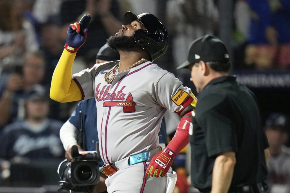 Atlanta Braves' Marcell Ozuna celebrates after his solo home run off Tampa Bay Rays pitcher Edwin Uceta during the eighth inning of a baseball game Friday, April 11, 2025, in Tampa, Fla. (AP Photo/Chris O'Meara)