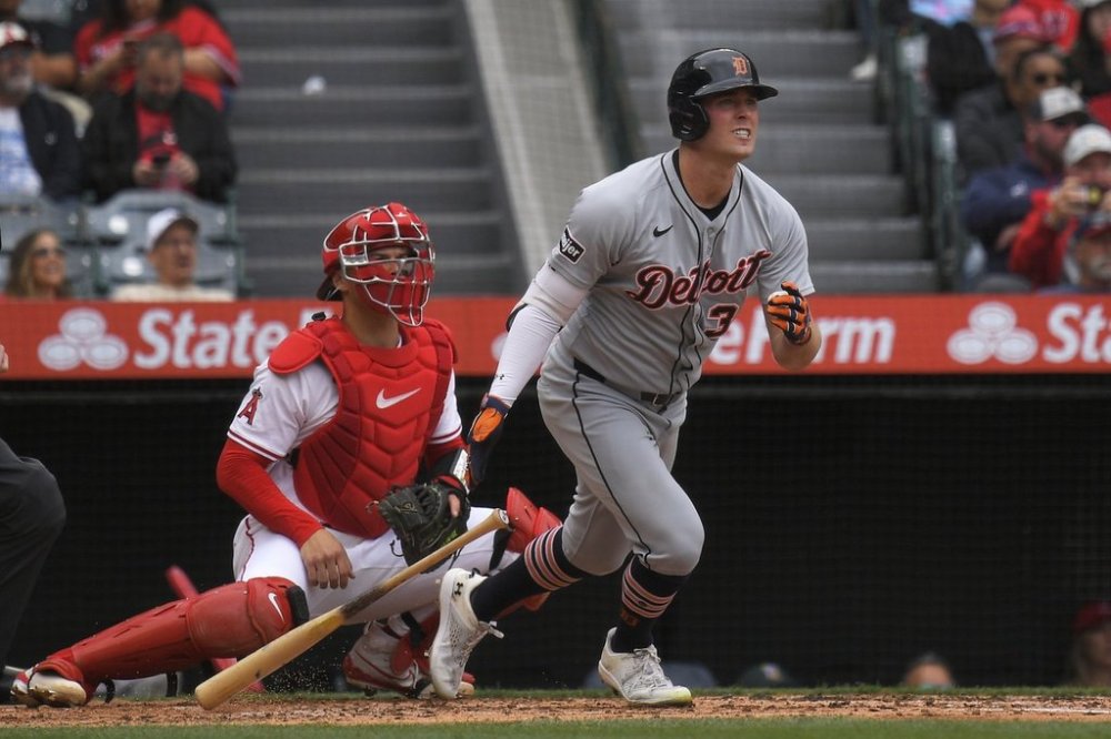 Detroit Tigers' Kerry Carpenter, right, hits a two RBI double as Los Angeles Angels catcher Logan O'Hoppe watches during the second inning of a baseball game Sunday, May 4, 2025, in Anaheim, Calif. (AP Photo/Mark J. Terrill)