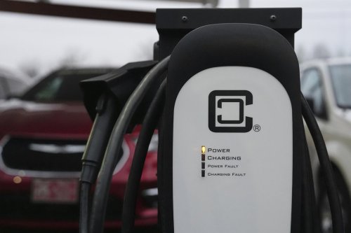 An electric vehicle charging station operates in a parking lot, Friday, April 11, 2025, in Evansville, Ind. (AP Photo/Joshua A. Bickel)
