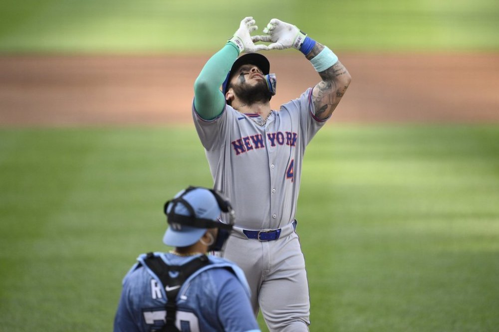 New York Mets' Francisco Alvarez, top, celebrates after his two-run home run in front of Washington Nationals catcher Keibert Ruiz, bottom, during the second inning of a baseball game, Saturday, April 26, 2025, in Washington. (AP Photo/Nick Wass)