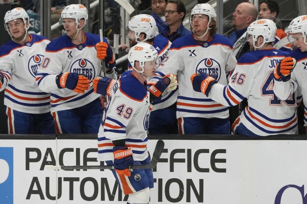 Edmonton Oilers defenseman Ty Emberson (49) is congratulated by teammates after scoring against the San Jose Sharks during the first period of an NHL hockey game in San Jose, Calif., Wednesday, April 16, 2025. (AP Photo/Jeff Chiu)