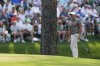 Rory McIlroy, of Northern Ireland, reacts after chipping into the water on the 15th hole during the first round at the Masters golf tournament, Thursday, April 10, 2025, in Augusta, Ga. (AP Photo/David J. Phillip)