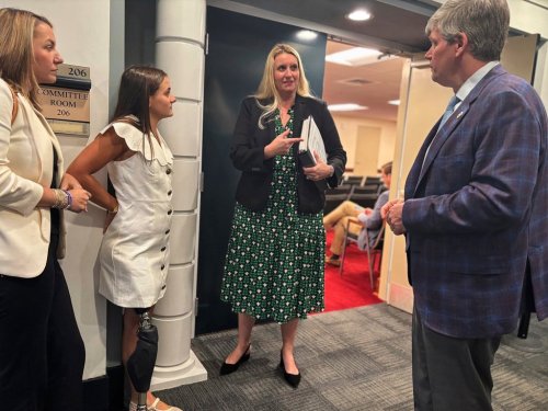 Lulu Gribbin, second from left, an Alabama teenager who survived a shark attack in 2024, speaks with attorney Charlanna Skaggs, second from right, and Alabama lawmaker Rep. David Faulkner, right, at the Alabama Statehouse in Montgomery, Ala., Wednesday, April 9, 2025. Faulkner has proposed an alert system, named for Gribbin, that would warn other beach goers when there has been an unprovoked shark attack in the area. (AP Photo/Kim Chandler)