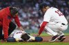 Boston Red Sox's Triston Casas lies on the field while comforted by manager Alex Cora (13) after an apparent injury during the second inning of a baseball game against the Minnesota Twins at Fenway Park, Friday, May 2, 2025, in Boston. (AP Photo/Charles Krupa)