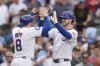 Chicago Cubs' Kyle Tucker (30), right, high-fives Ian Hapy after Tucker hit a two-run home run during the eighth inning of a baseball game against the Arizona Diamondbacks, Friday, April 18, 2025, in Chicago. (AP Photo/Erin Hooley)