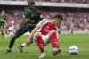 Arsenal's Gabriel Martinelli, front, and Brentford's Michael Kayode battle for the ball during the English Premier League soccer match between Arsenal and Brentford at Emirates Stadium in London, Saturday, April 12, 2025. (AP Photo/Frank Augstein)