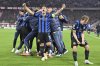 Inter's Lautaro Martinez, center, and Nicolo Barella, right, celebrate after the Champions League quarterfinals first leg soccer match between FC Bayern Munich and Inter Milan, at the Allianz Arena in Munich, Germany, Tuesday, April 8, 2025. (Peter Kneffel/dpa via AP)