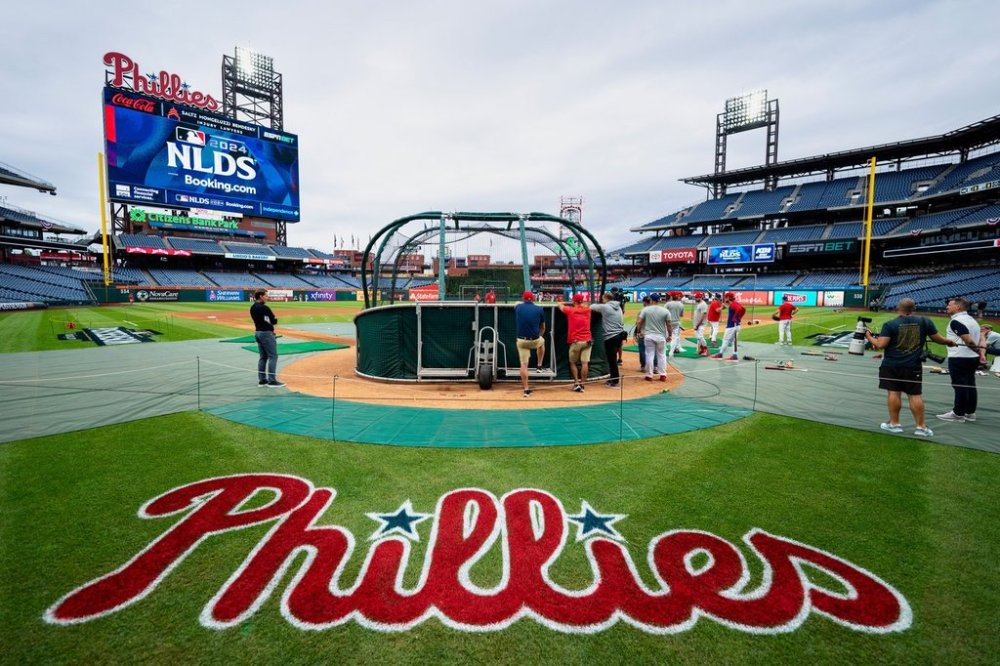 FILE - Philadelphia Phillies gather around the batting cage during a baseball workout, Friday, Oct. 4, 2024, in Philadelphia, ahead of the National League Division Series against the New York Mets. (AP Photo/Chris Szagola, File)