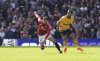 Manchester United's Noussair Mazraoui, left and Wolverhampton Wanderers' Matheus Cunha vie for the ball, during the English Premier League soccer match between Manchester United and Wolverhampton Wanderers, at Old Trafford, Manchester, England, Sunday, April 20, 2025. (Martin Rickett/PA via AP)