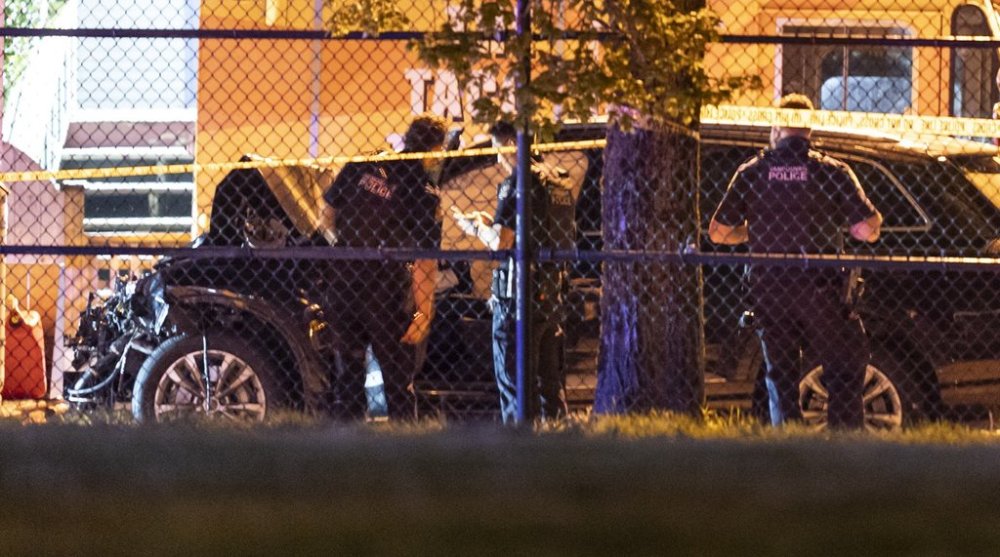 Vancouver Police look over a black car believed to be involved in an incident where a vehicle drove into a crowd at the Lapu Lapu Festival in Vancouver on Saturday April 26, 2025. THE CANADIAN PRESS/Rich Lam