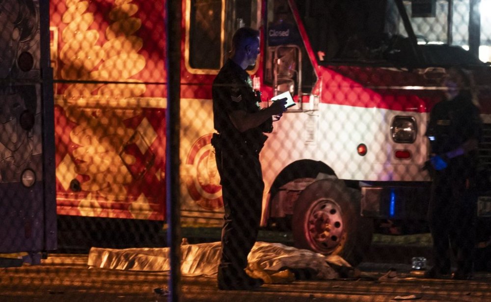 A victim lies near a food truck after a car drove into a crowd at the Lapu Lapu Festival in Vancouver on Saturday April 26, 2025. THE CANADIAN PRESS/Rich Lam