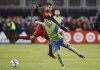 Toronto FC defender Steven Beitashour (33) defends as Seattle Sounders midfielder Nicolas Lodeiro (10) moves the balls during second half MLS Cup Final soccer action in Toronto on Saturday, December 9, 2017. THE CANADIAN PRESS/Mark Blinch