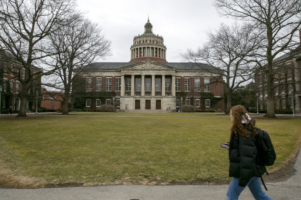 FILE - A student walks by the Rush Rhees Library at the University of Rochester, Feb. 22, 2023. (AP Photo/Ted Shaffrey, File)
