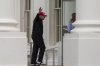 President Donald Trump waves as he returns to the White House, Sunday, April 20, 2025, in Washington. (AP Photo/Alex Brandon)