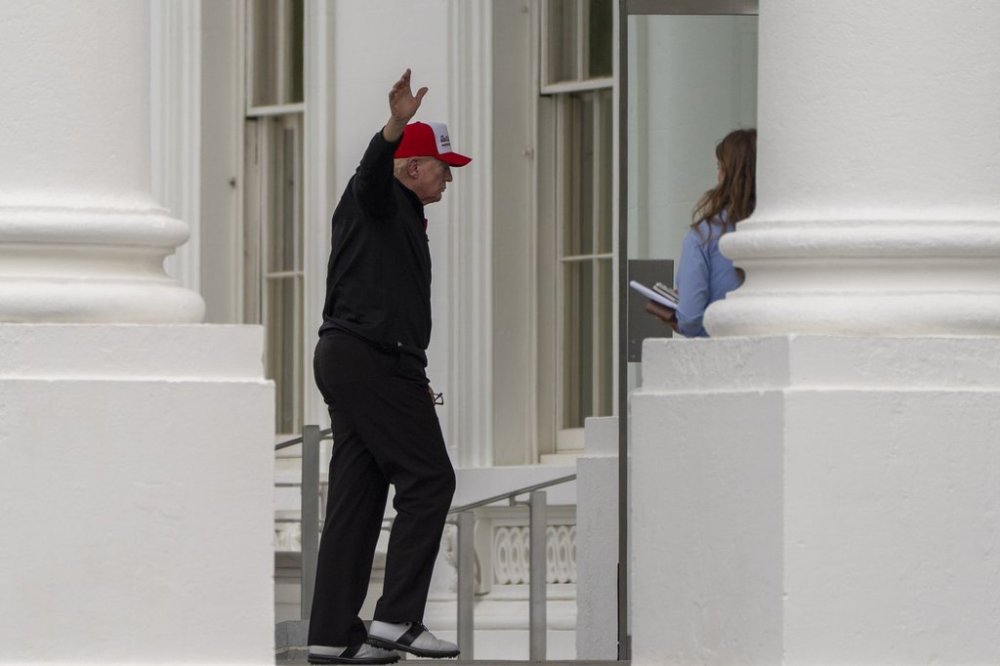 President Donald Trump waves as he returns to the White House, Sunday, April 20, 2025, in Washington. (AP Photo/Alex Brandon)