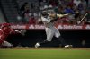 Pittsburgh Pirates Tommy Pham's bat breaks as he singles during the ninth inning of a baseball game against the Los Angeles Angels Wednesday, April 23, 2025, in Anaheim, Calif. (AP Photo/Eric Thayer)