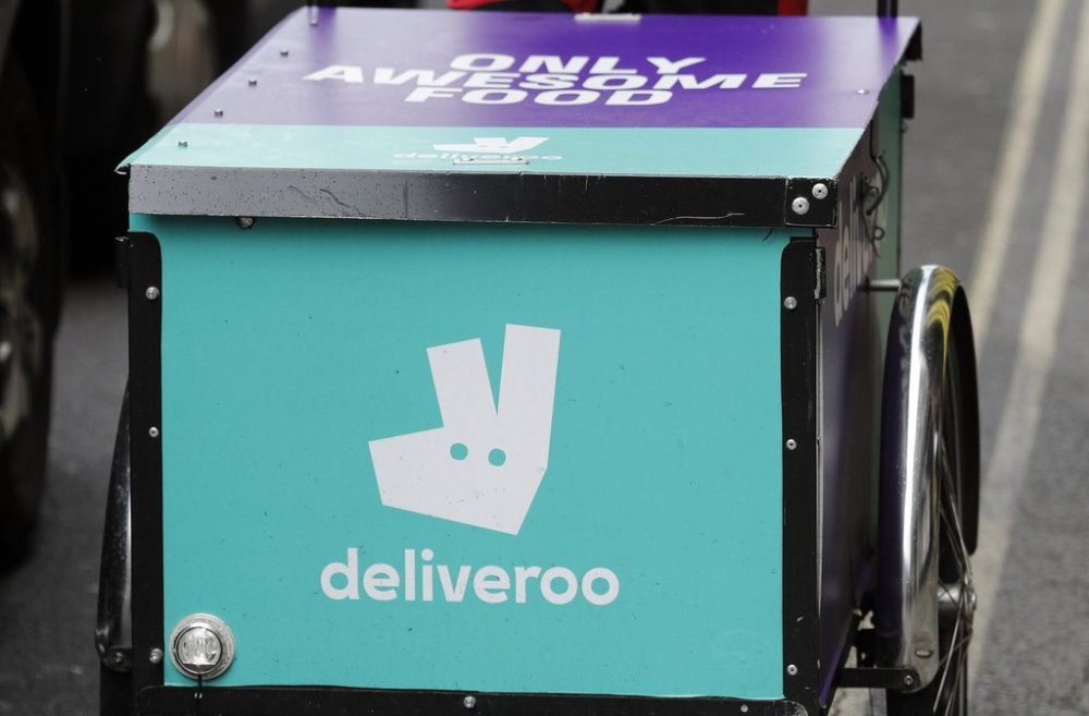 FILE - This July 11, 2017 file photo, shows a deliveroo logo on a bicycle in London. (AP Photo/Frank Augstein, File)