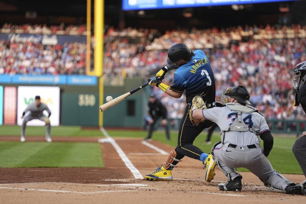 Philadelphia Phillies' Bryce Harper (3) hits a two-run home run off Miami Marlins pitcher Sandy Alcantara during the first inning of a baseball game, Friday, April 18, 2025, in Philadelphia. (AP Photo/Matt Rourke)