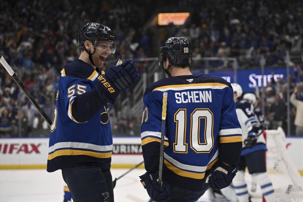 St. Louis Blues' Brayden Schenn (10) celebrates with Colton Parayko (55) after scoring against the Winnipeg Jets during the second period in Game 4 of an NHL hockey first-round playoff series Sunday, April 27, 2025, in St. Louis. (AP Photo/Connor Hamilton)
