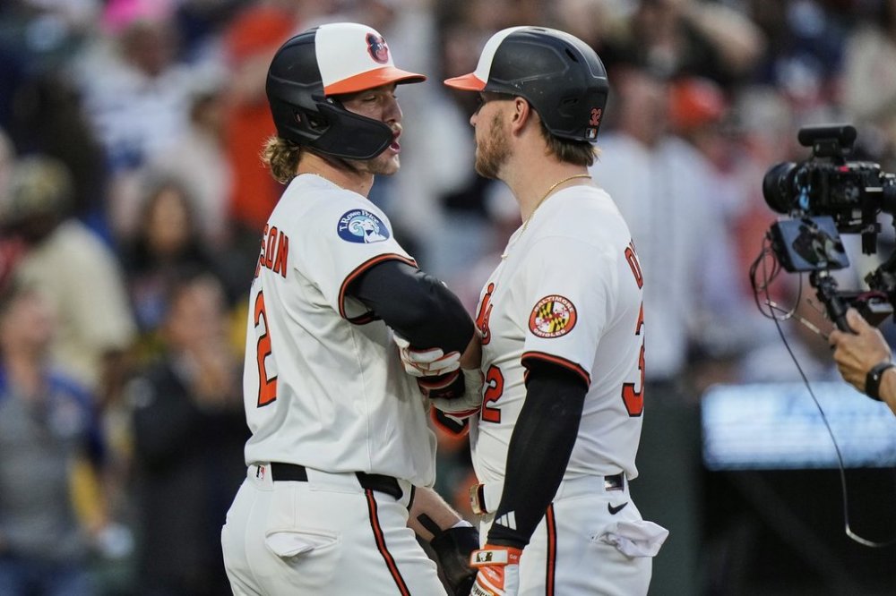 Baltimore Orioles' Ryan O'Hearn, center right, celebrates with Gunnar Henderson (2) after hitting a three-run home run during the third inning of a baseball game against the New York Yankees, Monday, April 28, 2025, in Baltimore. (AP Photo/Stephanie Scarbrough)