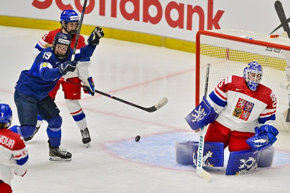 Finland's Ida Kuoppal, left, celebrates after her team scored as Czech Republic's Klara Hymlarova and goalkeeper Klara Peslarova react during a Group A match at the women's world ice hockey championships, Saturday, April 12, 2025, in Ceske Budejovice, Czech Republic. (Václav Pancer/CTK via AP)