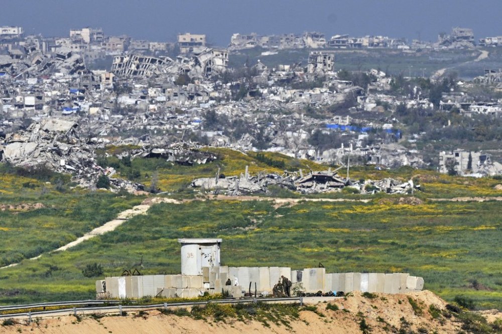 Israeli soldiers gather next to a military post on the border with Gaza Strip, in southern Israel, Tuesday, March 18, 2025. (AP Photo/Ohad Zwigenberg)