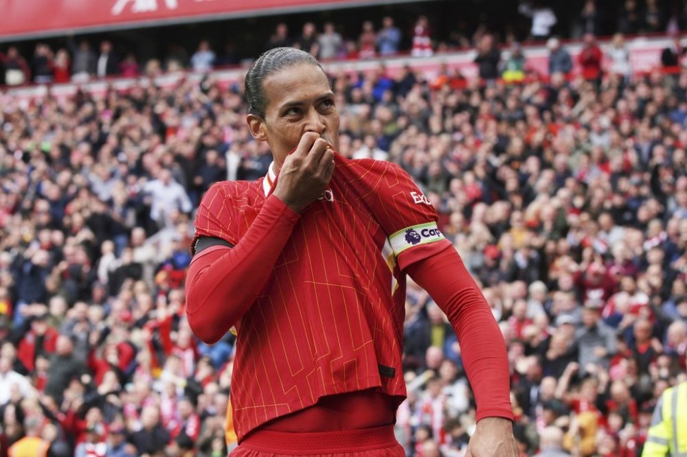 Liverpool's Virgil van Dijk celebrates after scoring his side's second goal during the English Premier League soccer match between Liverpool and West Ham United at Anfield in Liverpool, Sunday, April 13, 2025. (AP Photo/Ian Hodgson)
