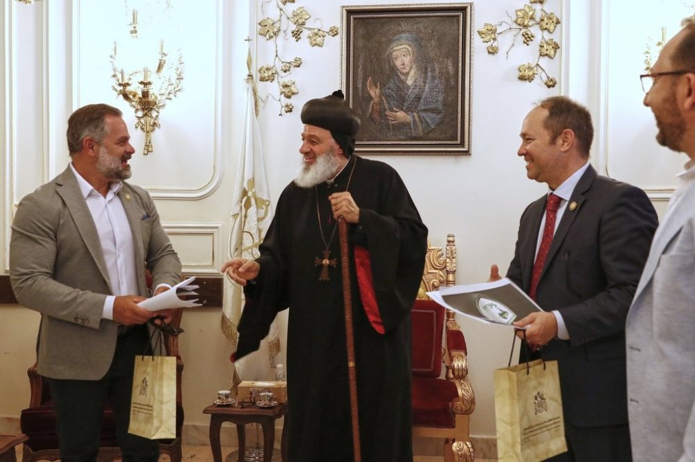 U.S. congressmen Cory Mills (R-FL), left, and Martin Stutzman (R-IN), second from right, meet Mor Ignatius Aphrem II, a Syrian-American Christian prelate serving as the Patriarch of the Syriac Orthodox Church in Damascus Friday, April 18, 2025. Mills and Stutzman arrived on an unofficial visit organized by a Syrian-American nonprofit, the first visit by U.S. legislators since the fall of former Syrian President Bashar Assad in December.(AP Photo/Omar Sanadiki)
