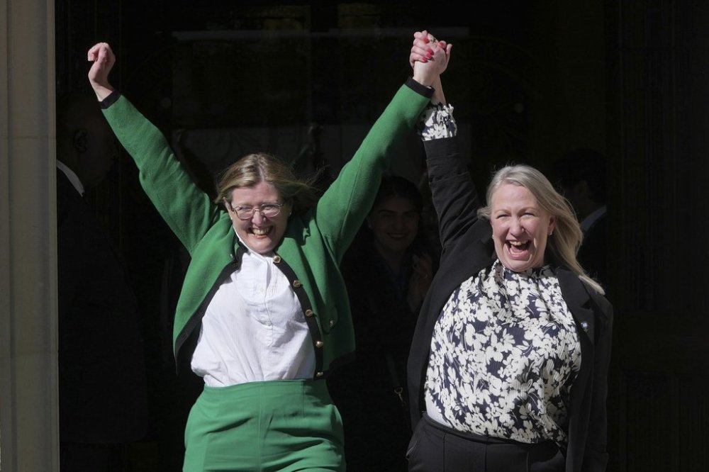 Marion Calder and Susan Smith from For Women Scotland, celebrate outside the Supreme Court to challenge gender recognition laws, in London, Wednesday, April 16, 2025. (AP Photo/Kin Cheung)