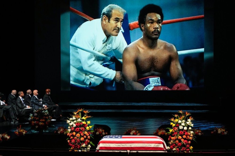 A photo of George Foreman sitting in the corner of a boxing ring is shown during a tribute video honouring Olympic and world champion boxer and minister Foreman during his memorial service at Wortham Theater Center in Houston, Monday, April 14, 2025. (Brett Coomer/Houston Chronicle via AP)