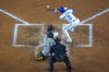 Texas Rangers' Leody Taveras (3) drops a sacrifice bunt in front of Oakland Athletics catcher Shea Langeliers (23) and home plate umpire James Hoye during the third inning of a baseball game Wednesday, April 30, 2025, in Arlington, TX. (AP Photo/Julio Cortez)