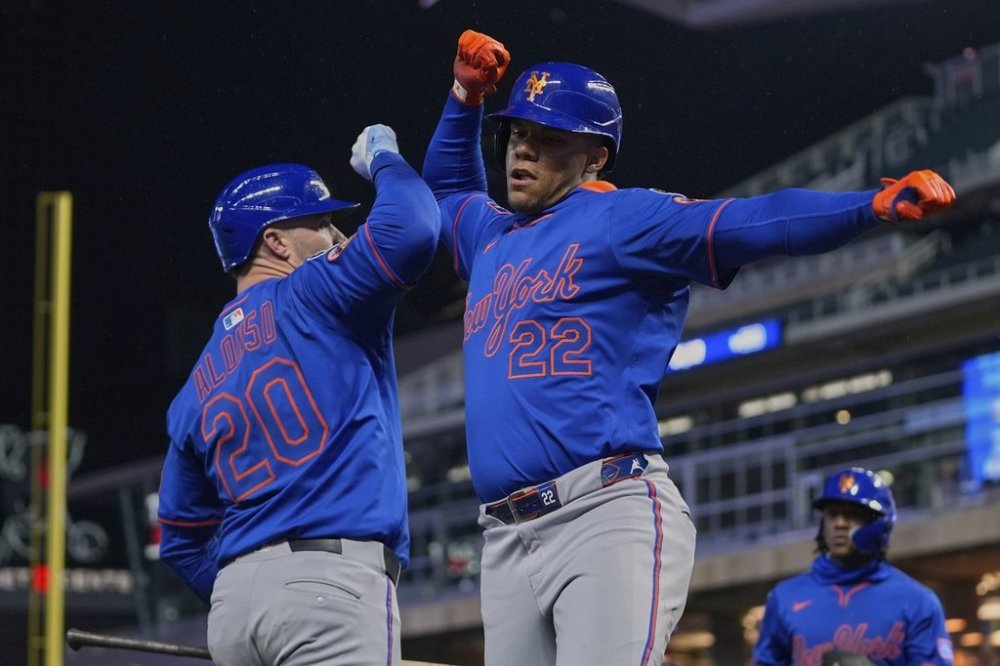 New York Mets' Juan Soto (22) celebrates with Pete Alonso (20) after hitting a two-run home run during the seventh inning of a baseball game against the Minnesota Twins, Monday, April 14, 2025, in Minneapolis. (AP Photo/Abbie Parr)