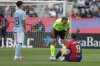 Referee Mario Melero Lopez talks with Barcelona's Robert Lewandowski during a Spanish La Liga soccer match between Barcelona and Celta de Vigo at the Lluis Companys Olympic stadium in Barcelona, Spain, Saturday, April 19, 2025. (AP Photo/Joan Monfort)