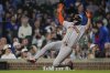 San Francisco Giants' Willy Adames (2) slides into home to score on a single from designated hitter Wilmer Flores (41) during the eleventh inning of a baseball game against the Chicago Cubs, Tuesday, May 6, 2025, in Chicago. (AP Photo/Erin Hooley)