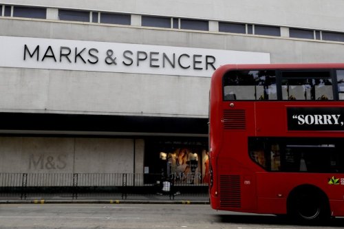 FILE - A bus passes a branch of Marks and Spencer in London, Tuesday, Aug. 18, 2020. (AP Photo/Kirsty Wigglesworth, file)