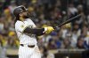 San Diego Padres' Fernando Tatis Jr. (23) hits a two-run home run during the eighth inning of a baseball game against the Chicago Cubs Monday, April 14, 2025, in San Diego, Calif. (AP Photo/Denis Poroy)