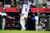 Atlanta Braves' Alex Verdugo (8) is greeted at the dugout by Atlanta Braves manager Brian Snitker (43) after scoring against the Minnesota Twins during the third inning of a baseball game Saturday, April 19, 2025, in Atlanta. (AP Photo/ John David Mercer)