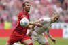 Bayern's Harry Kane, left, duels for the ball with Mainz's Andreas Hanche-Olsen during the German Bundesliga soccer match between Bayern Munich and 1. FSV Mainz 05 at the Allianz Arena in Munich, Germany, Saturday, April 26, 2025. (AP Photo/Matthias Schrader)