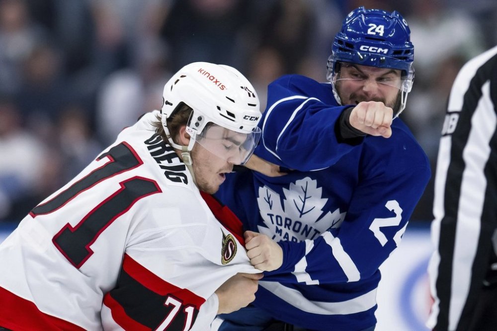 FILE - Toronto Maple Leafs left wing Scott Laughton, right, and Ottawa Senators center Ridly Greig fight during the second period of an NHL hockey game in Toronto on Saturday, March 15, 2025. (Christopher Katsarov/The Canadian Press via AP File)