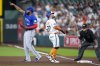 Toronto Blue Jays first baseman Vladimir Guerrero Jr., left, points to left fielder Alan Roden after Guerrero Jr. completed a double play off Houston Astros' Jose Altuve, centre, during the first inning of a baseball game Monday, April 21, 2025, in Houston. (AP Photo/Eric Christian Smith)