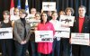 Montreal Mayor Valerie Plante, centre and Nathalie Provost, left, survivor of the 1989 femicide at Ecole polytechnique and spokesperson for PolySeSouvient, a gun-control advocacy organization, hold signs with a student group during a press conference about stricter gun control in Montreal on Tuesday, Nov. 19, 2024. THE CANADIAN PRESS/Christinne Muschi