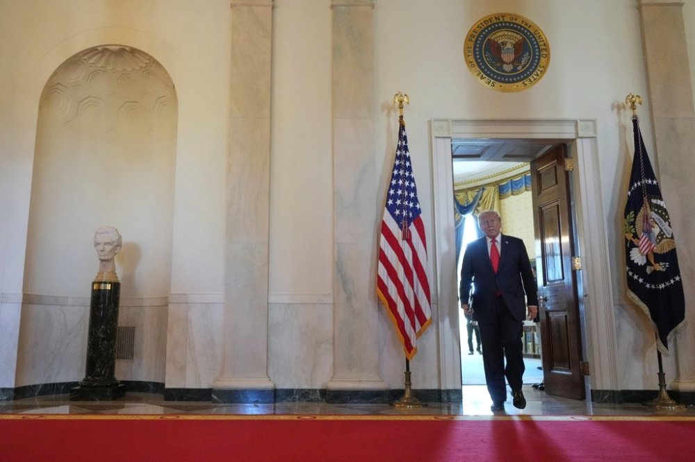 President Donald Trump arrives to speak at the Commander-in-Chief trophy presentation to the Navy Midshipman football team in the East Room of the White House, Tuesday, April 15, 2025, in Washington. (AP Photo/Alex Brandon)