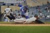 Minnesota Twins' Byron Buxton beats the tag by New York Mets catcher Luis Torrens (13) to score during the fifth inning of a baseball game Tuesday, April 15, 2025, in Minneapolis. (AP Photo/Abbie Parr)