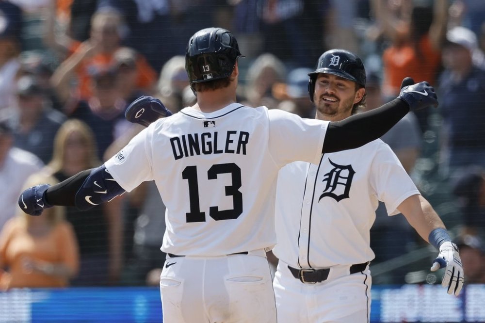 Detroit Tigers' Dillon Dingler (13) is greeted by Zach McKinstry, right, after hitting a 2-run home run during the eighth inning of a baseball game against the San Diego Padres, Wednesday, April 23, 2025, in Detroit. (AP Photo/Duane Burleson)