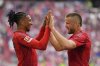 Bayern's Eric Dier, right, celebrates with Bayern's Michael Olise after scoring his side's third goal during the German Bundesliga soccer match between Bayern Munich and 1. FSV Mainz 05 at the Allianz Arena in Munich, Germany, Saturday, April 26, 2025. (AP Photo/Matthias Schrader)