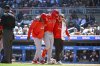 Los Angeles Angels' Nolan Schanuel, center, is helped off the field after fouling off a ball into his knee on a pitch by Minnesota Twins pitcher Simeon Woods Richardson during the fourth inning of a baseball game, Saturday, April 26, 2025, in Minneapolis. (AP Photo/Craig Lassig)